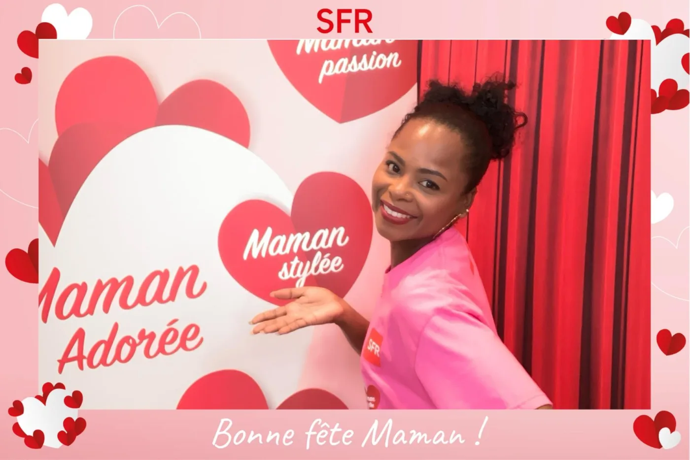Cadre rose semé de cœurs pour la fête des mères d'un opérateur télécom : une participante en tee-shirt de la marque pose devant un mur de cœurs « Maman adorée »